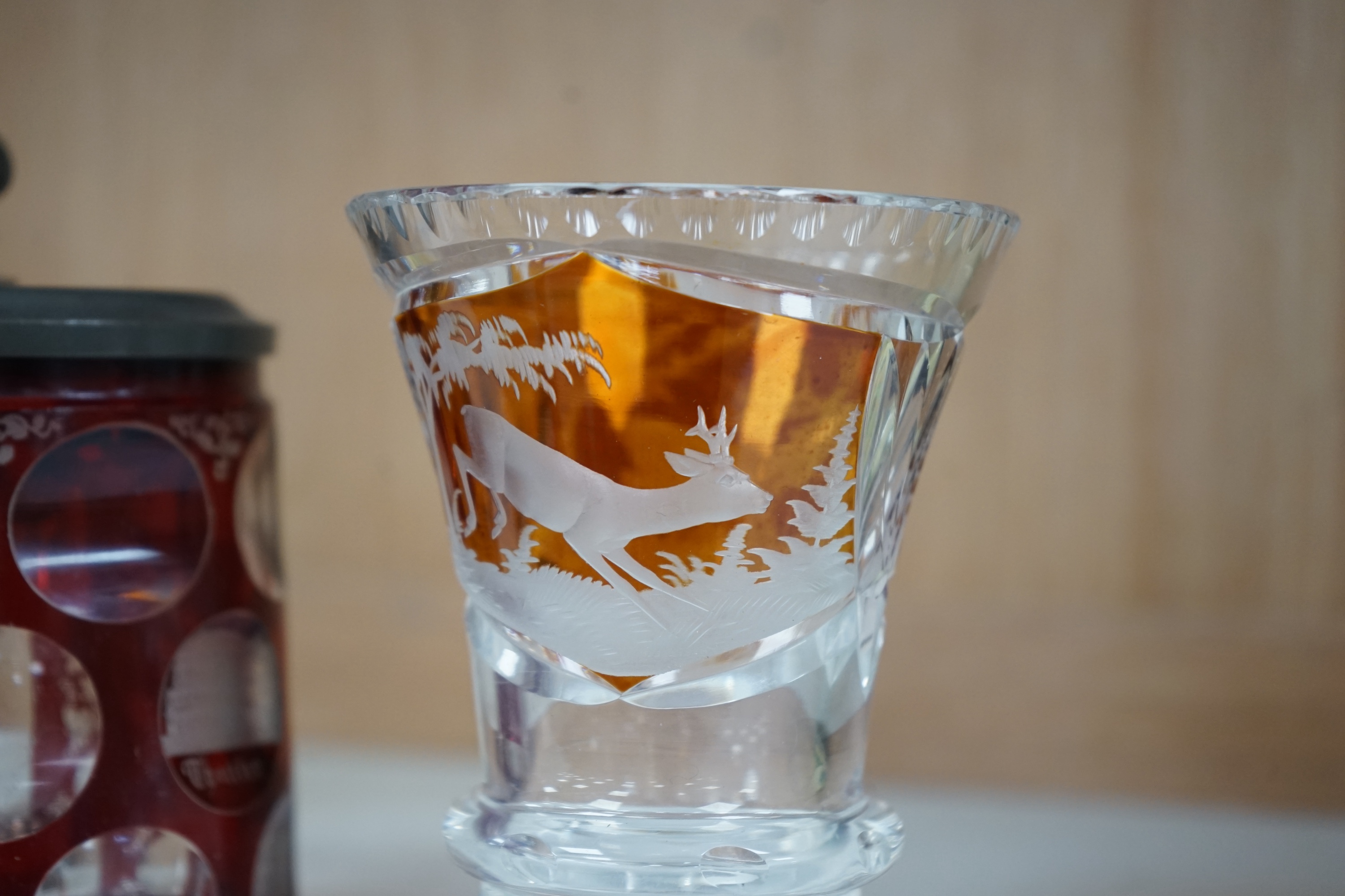 Two 19th century Bohemian glasses and a similar tankard, amber glass 15cm high. Condition - good